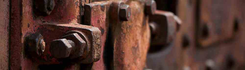 blurry photography of red metal auto part